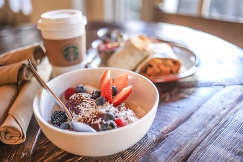 a bowl of cereal with fruit and a cup of coffee at The Wigwam in Litchfield Park