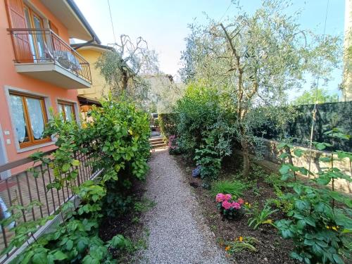 a garden in front of a house with plants at Lorena house in Brenzone sul Garda