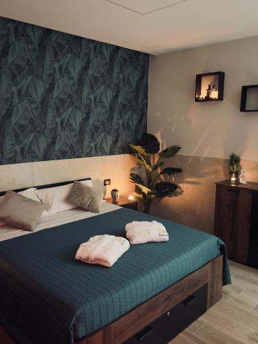 a bedroom with a bed with two towels on it at Eden Room&Spa in Torremaggiore