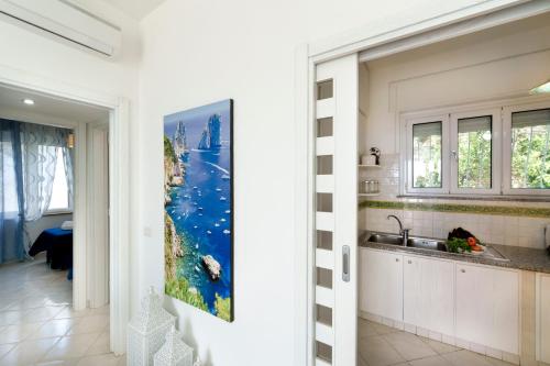 a kitchen with a painting on the wall at Belvedere apartament stunning sea view in Nerano