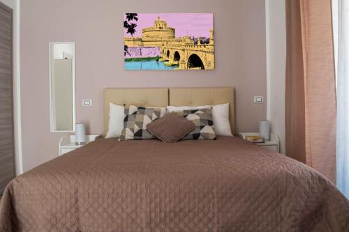 a bedroom with a bed and a painting on the wall at Tiber Rooms Testaccio in Rome