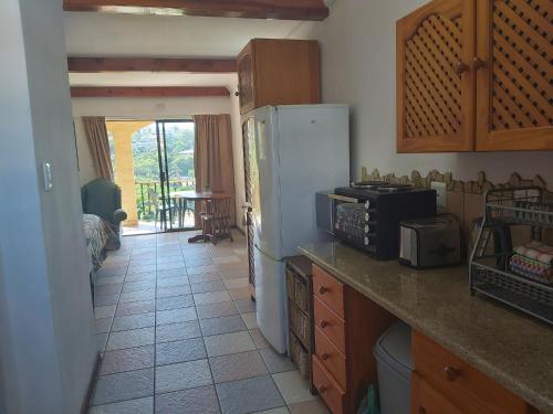 a kitchen with a white refrigerator and a table at Crayfish Inn no.8 in Ramsgate