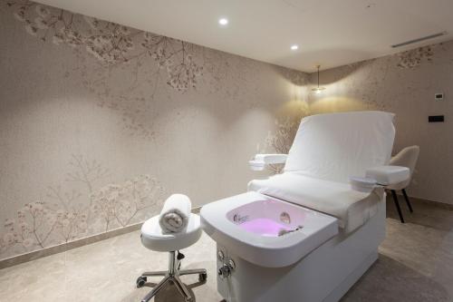 a hospital room with a bed and a sink at Hotel Turist in Varaždin