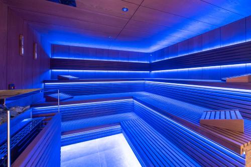 an empty pool room with blue lights in it at Hotel Turist in Varaždin