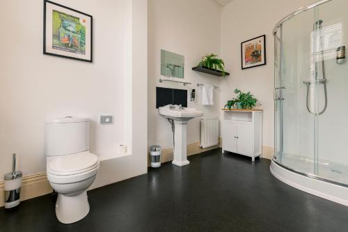 a bathroom with a toilet and a sink and a shower at Rowntree Lodge in Scarborough