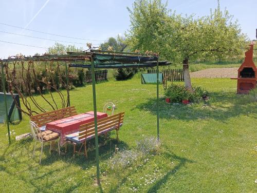 a picnic table and bench in a yard with a gazebo at Cookies Old House Visoko in Visoko