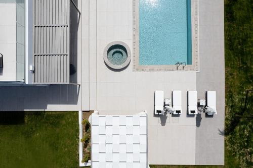 an overhead view of a building with a swimming pool at Alma Villa, 2000m2 Luxury Living, by ThinkVilla in Angeliana