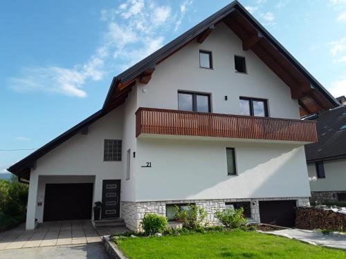 a white house with a brown roof at Hiša Višnar in Bled