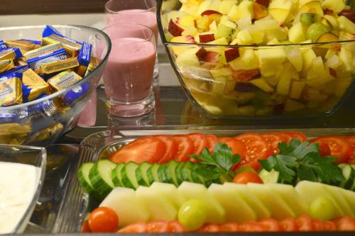 a tray of food with fruits and vegetables on a table at INA Hotel Royal in Cologne
