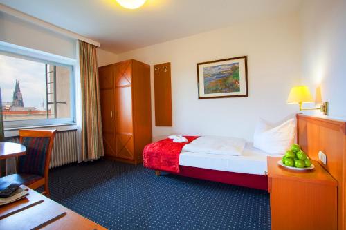 a hotel room with a bed and a window at INA Hotel Royal in Cologne