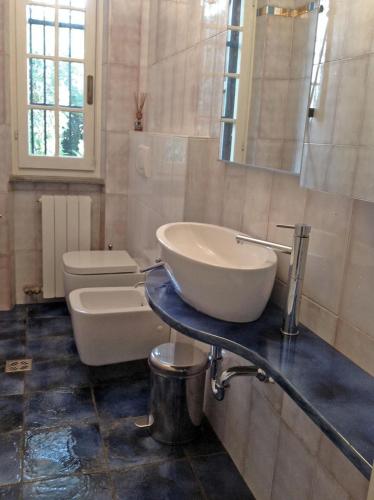 a bathroom with a sink and a toilet at Holiday home Villetta Cinquale in Cinquale