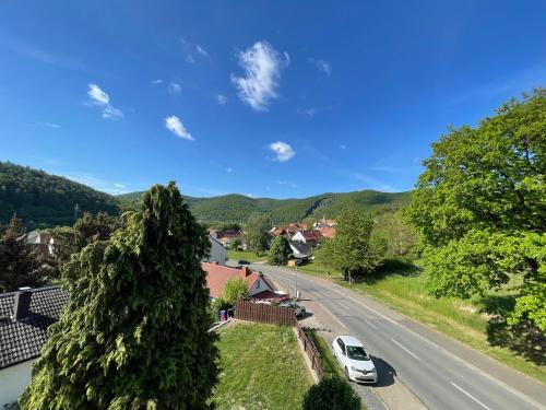 a house with a car parked on the side of a road at Maharaja Ferienhaus in Hemfurth-Edersee