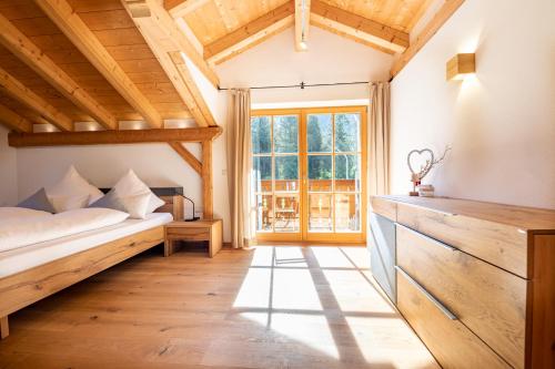 a bedroom with a bed and a large window at am Josefibrunnen in Farchant