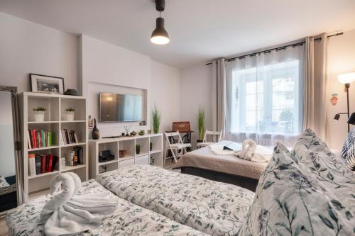 a living room with two beds and a window at 06 Gdynia Centrum - Apartament Mieszkanie dla 4 os in Gdynia
