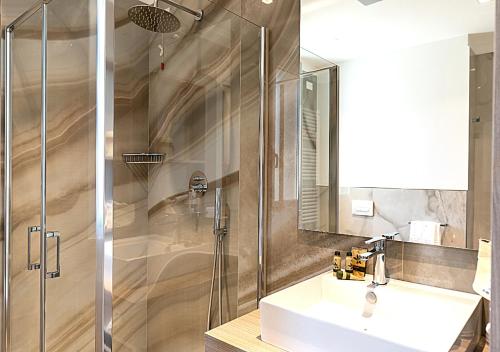 a bathroom with a sink and a shower at Hotel Savini in Bellaria-Igea Marina