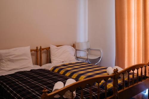 a bedroom with a bed and a chair in it at Nafplion comfort aprt next to fortress of palamidi in Nafplio