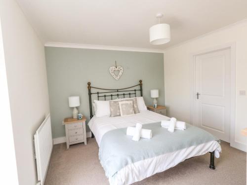 a bedroom with a large bed with two pillows at Pebbles Reach in Portland