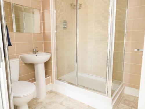 a bathroom with a shower and a toilet and a sink at Pebbles Reach in Portland
