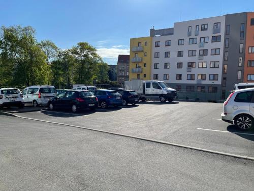 a parking lot with a lot of cars parked at Penzion u Vlčků in Cheb