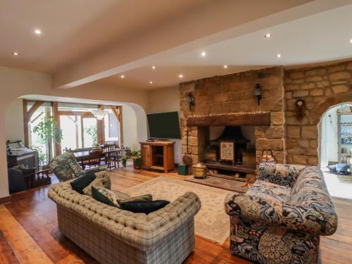 a living room with two couches and a stone fireplace at Dean Mews in Leeds