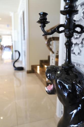 a black statue of a hand holding a pole at Hotel Villa Pascucci in Durrës