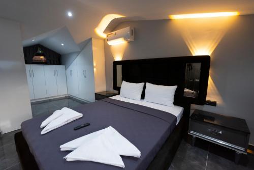 a bedroom with a large bed with white pillows at Diamond Port Gocek in Göcek