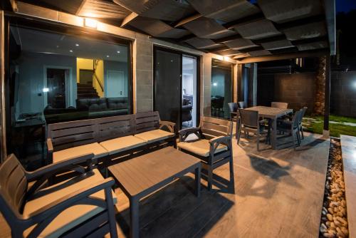 a patio with tables and chairs and a couch at Diamond Port Gocek in Göcek