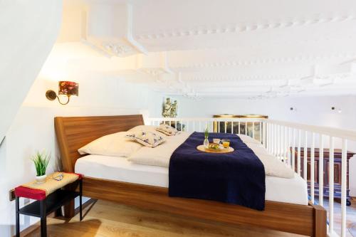 a bedroom with a bed with a table on it at Ferienwohnung Saalstube - Schloss Adolphsburg in Kirchhundem