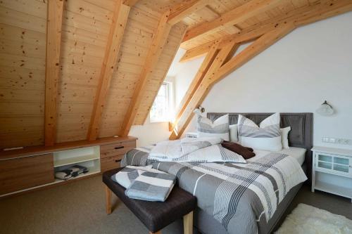 a bedroom with a bed and a wooden ceiling at Lerchenberghof - barrierefreies Familien Landhotel mit FeWo, FeZi - Spielplatz Reiten Segway PT und mehr in Kottmar