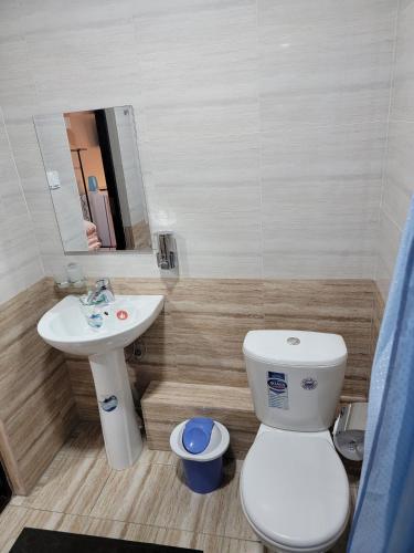 a bathroom with a toilet and a sink at MELODIA Guest House in Bukhara