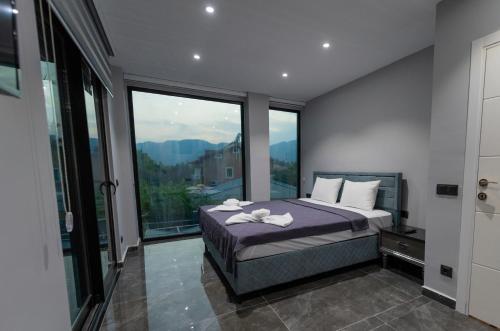 a bedroom with a bed and a large window at Diamond Port Gocek in Göcek