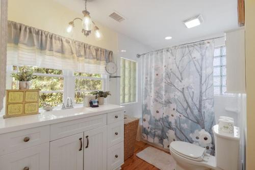 a bathroom with a toilet and a shower curtain at 817 E Ashely Ave Pleasant Breeze in Folly Beach