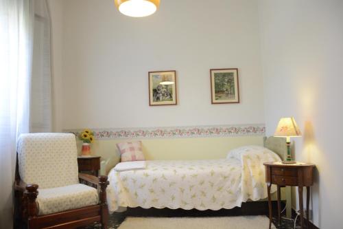 a bedroom with a bed and a chair at Bed & Bike Belfiore in Montagnana