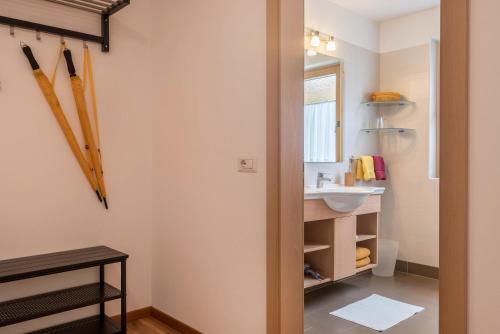 a bathroom with baseball bats hanging on the wall at Hilber App Fermeda in Villnoss