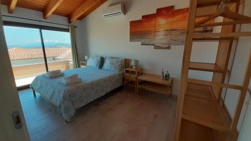a bedroom with a bed and a large window at b&b U Punenti in La Maddalena