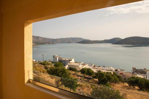 a view from a window of a town and a body of water at Elounda Heights (Adults Only) in Elounda