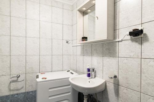 a white bathroom with a sink and a mirror at ''Meraviglia casa'' Ariadne in Kato Daratso