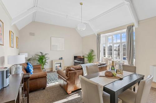 a living room with a table and a couch at The Torcroft Apartments at Bedford House in Torquay