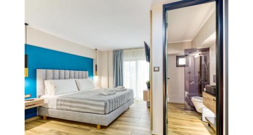 a hotel room with a bed and a bathroom at Sapphire Blue Suites in Kissamos