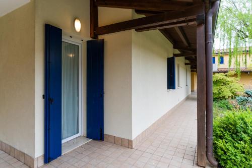 a hallway with a blue door in a building at Pini Village Lido Altanea in Caorle