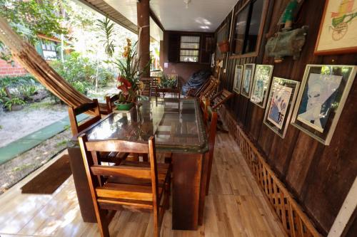 a dining room with a glass table and chairs at A Ilha Verde Hotel Pousada na Praia in Ilha do Mel