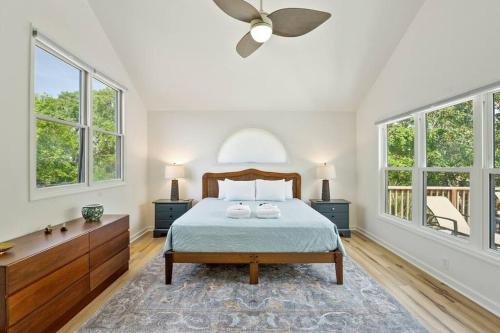 a bedroom with a bed and two windows at 307 W Indian - The Prickly Pear in Folly Beach