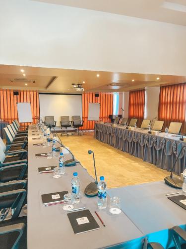 a row of tables in a large room with chairs at Season Paradise in Thulusdhoo