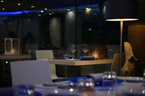 a table in a restaurant with wine glasses on it at A Point Porto Ercole Resort & Spa in Porto Ercole