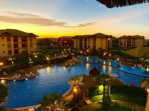une vue d'une piscine dans un complexe hôtelier la nuit dans l'établissement VG-Sun Deluxe Bungalow Cumbuco Beach View Top WiFi, à Cumbuco