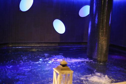 a swimming pool with blue and white lights at A Point Porto Ercole Resort & Spa in Porto Ercole