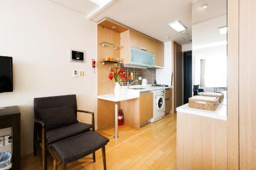 a kitchen with a stove, sink, and refrigerator at Hotel Hu Incheon Airport in Incheon