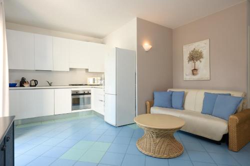 a living room with a couch and a table at Villa Carlotta Jesolo Lido in Lido di Jesolo