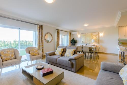 a living room with a couch and a table at Boavista Golf and Spa Resort - Bayview in Lagos