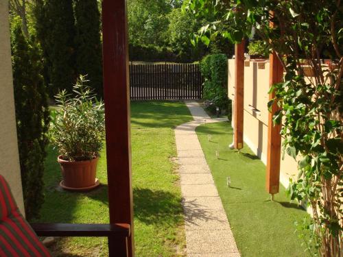a view of a garden with a plant on the grass at Brasch Apartman in Fertőrákos